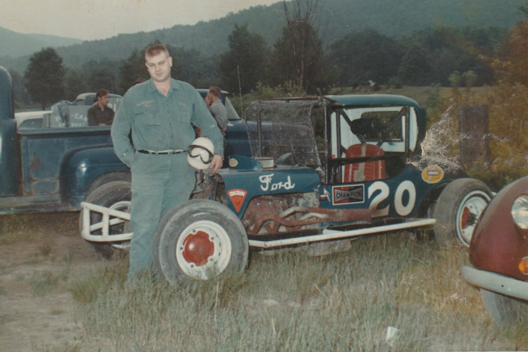 Jim Nichols standing next to his race car.