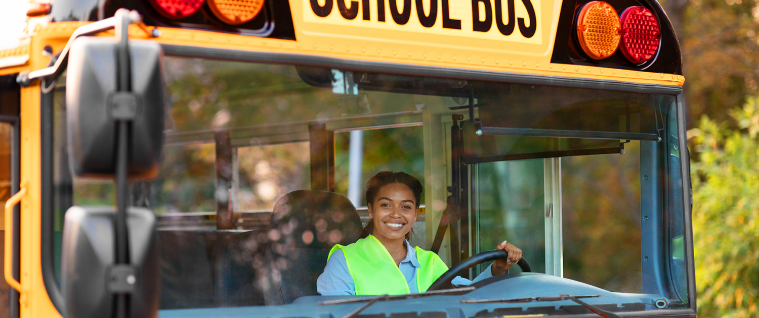 A person driving a school bus.